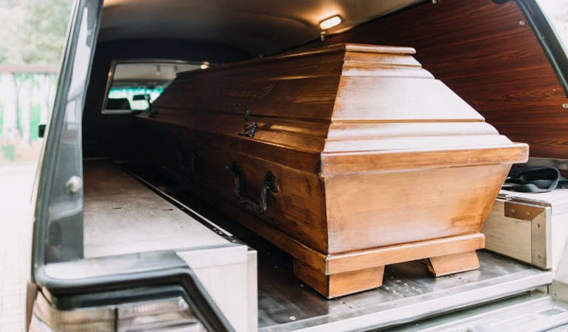 Casket placed inside a funeral car